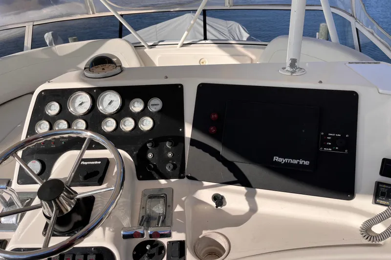 Slide: The Image of Helm of 2001 Silverton 42C yacht with Raymarine navigation system and gauges. - 14