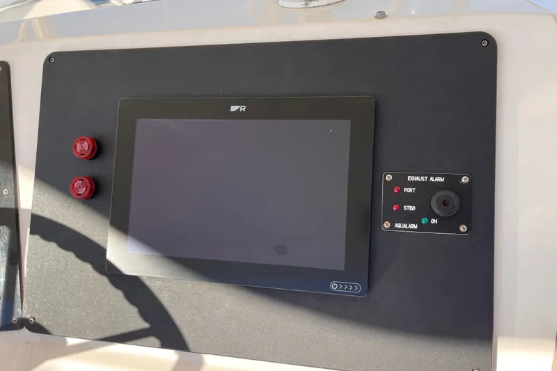 Slide: The Image of Control panel of a 2001 Silverton 42C boat with display and alarm system. - 16