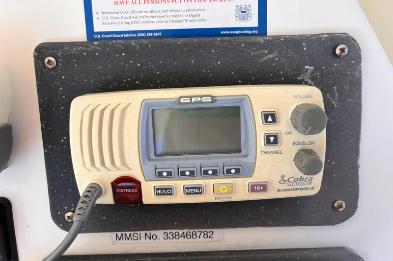 Slide: The Image of Cobra Marine GPS radio on 2001 Silverton 42C boat dashboard with distress button. - 18
