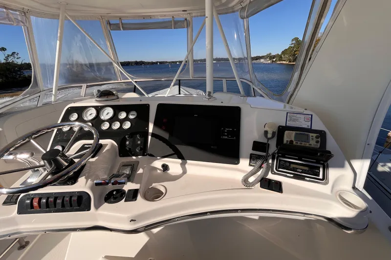 Slide: The Image of Helm of 2001 Silverton 42C yacht with steering wheel and navigation instruments. - 23