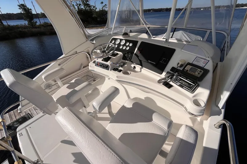 Slide: The Image of 2001 Silverton 42C yacht helm with steering wheel, controls, and navigation equipment. - 29