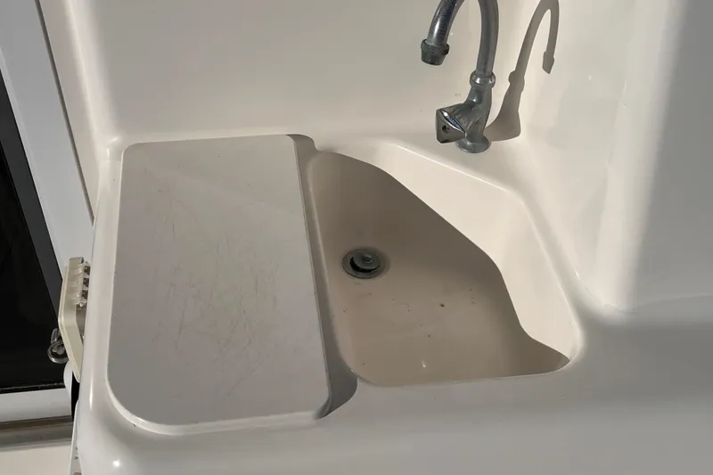 Slide: The Image of 2001 Silverton 42C boat sink with faucet and cover, white finish. - 36