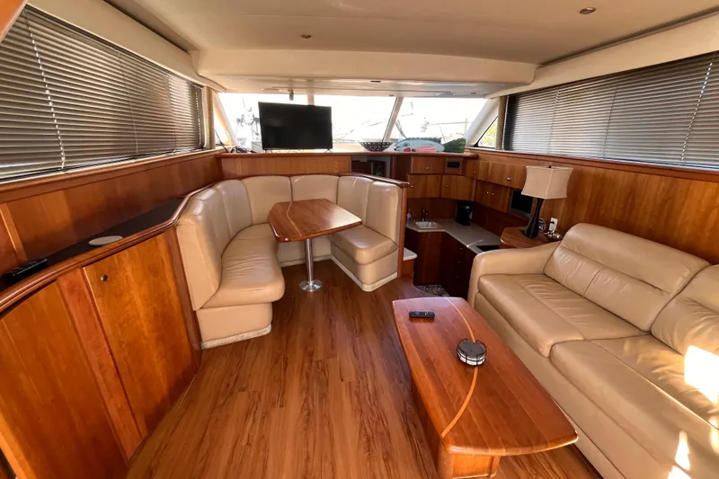 Slide: The Image of Luxurious interior of 2001 Silverton 42C yacht with leather seating and wooden finishes. - 38
