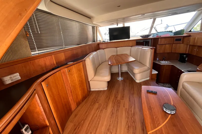 Slide: The Image of Luxurious interior of 2001 Silverton 42C yacht with wood finish and cozy seating area. - 39
