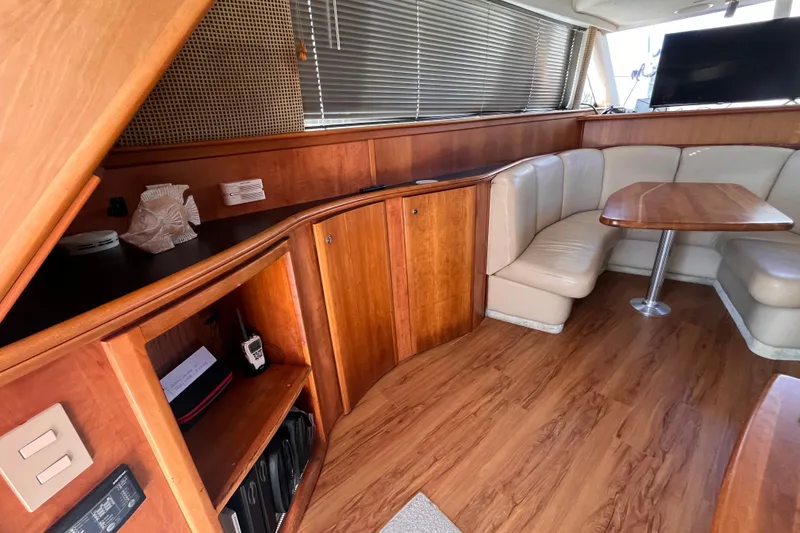 Slide: The Image of Luxurious 2001 Silverton 42C yacht interior with wood finish and cozy seating area. - 40