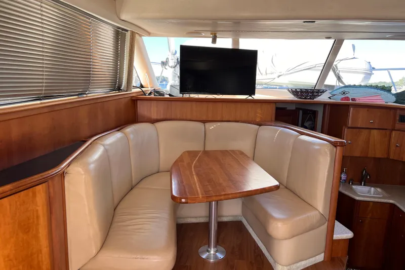 Slide: The Image of Luxurious interior of 2001 Silverton 42C yacht with plush seating and wooden table. - 41