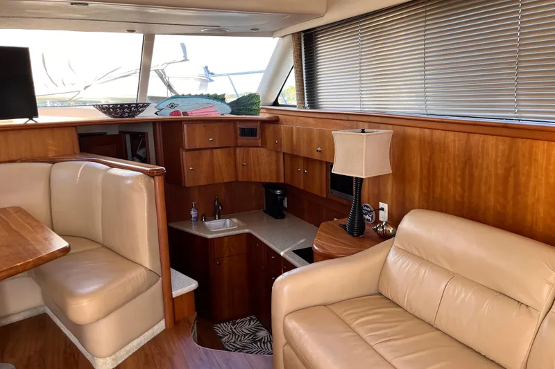 Slide: The Image of Interior of 2001 Silverton 42C yacht with leather seating and wooden cabinetry. - 42