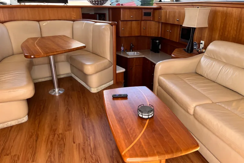 Slide: The Image of Interior of 2001 Silverton 42C yacht with leather seating and wooden furnishings. - 43