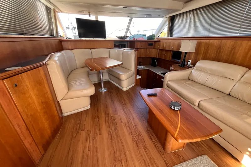 Slide: The Image of Luxurious interior of a 2001 Silverton 42C yacht with leather seating and wood finishes. - 44