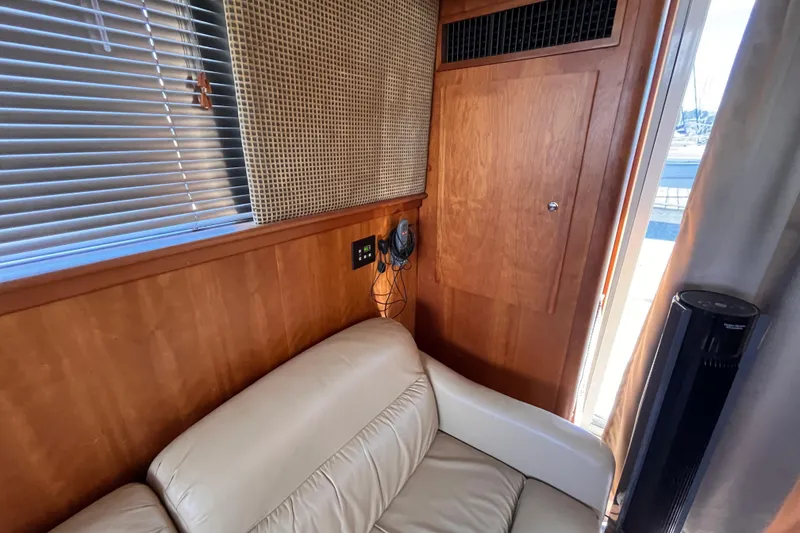 Slide: The Image of Interior of 2001 Silverton 42C yacht with beige leather seating and wooden paneling. - 47