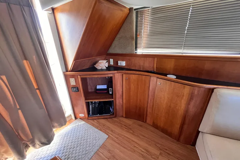 Slide: The Image of Interior of 2001 Silverton 42C yacht with wooden cabinetry and blinds. - 48
