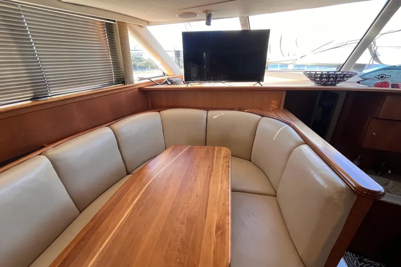 Slide: The Image of 2001 Silverton 42C yacht interior with cozy dining area and TV. - 50