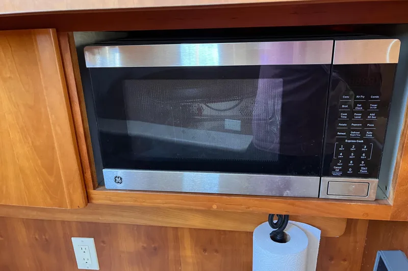 Slide: The Image of GE microwave in a 2001 Silverton 42C yacht kitchen, with wooden cabinetry. - 51