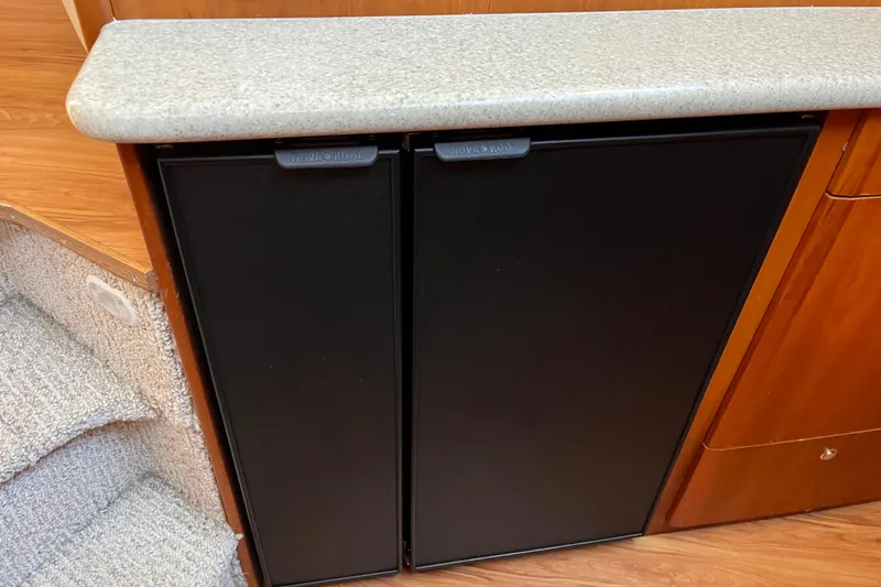 Slide: The Image of 2001 Silverton 42C yacht interior with Nova Kool refrigerator and wooden cabinetry. - 57