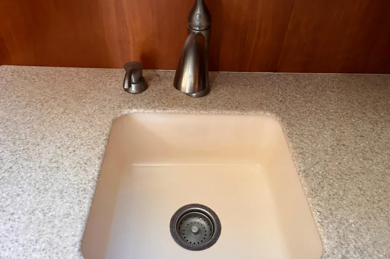 Slide: The Image of Kitchen sink with modern faucet in 2001 Silverton 42C yacht. - 58