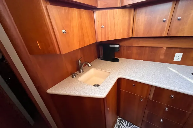 Slide: The Image of 2001 Silverton 42C yacht kitchen with wooden cabinets and countertop sink. - 59