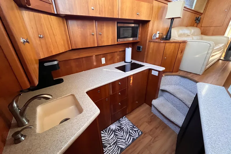 Slide: The Image of Interior of 2001 Silverton 42C yacht with modern kitchen and cozy seating area. - 60