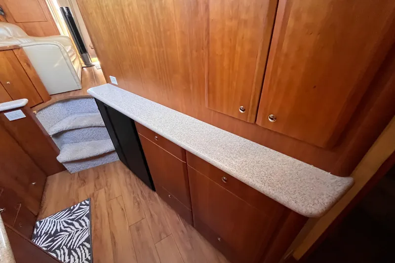 Slide: The Image of Interior of 2001 Silverton 42C yacht with wooden cabinets and carpeted stairs. - 61