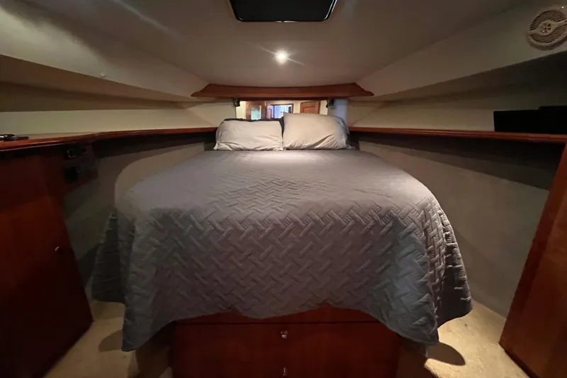 Slide: The Image of Interior cabin of 2001 Silverton 42C yacht with cozy bed and wooden accents. - 69