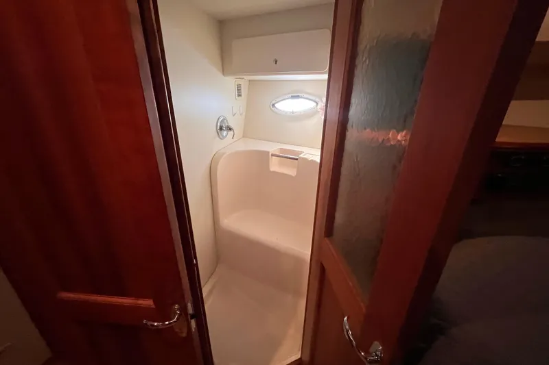 Slide: The Image of 2001 Silverton 42C yacht bathroom with shower and wooden door. - 71