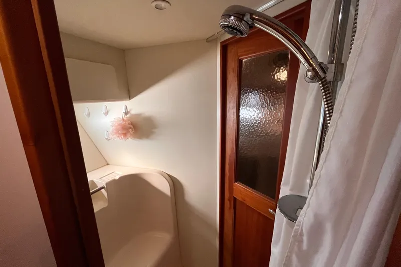 Slide: The Image of Bathroom interior of 2001 Silverton 42C yacht with shower and wooden door. - 77