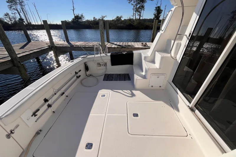 Slide: The Image of 2001 Silverton 42C yacht deck with dockside view and sunny weather. - 8
