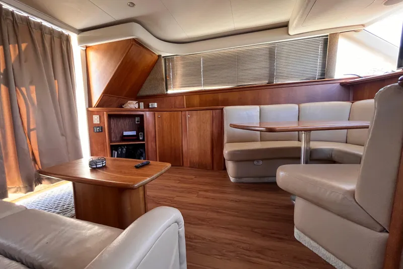 Slide: The Image of Luxurious interior of a 2001 Silverton 42C yacht with wood accents and leather seating. - 81