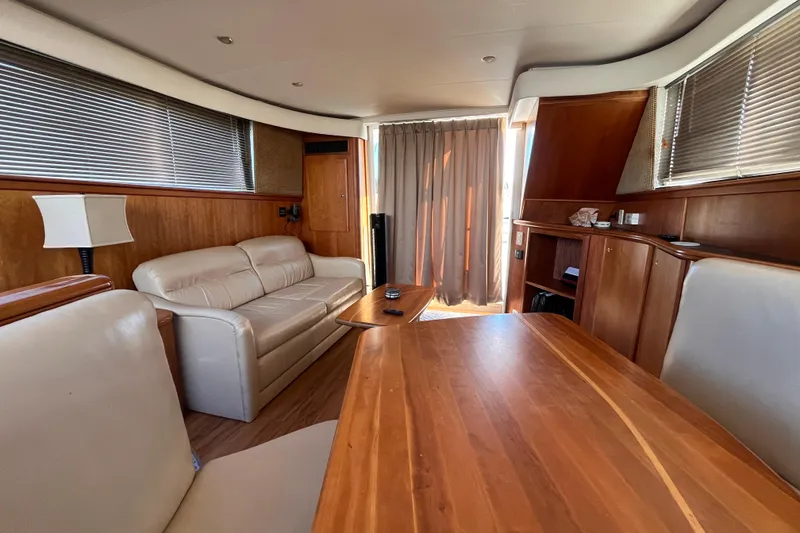 Slide: The Image of Interior of 2001 Silverton 42C yacht with wooden furnishings and leather seating. - 82