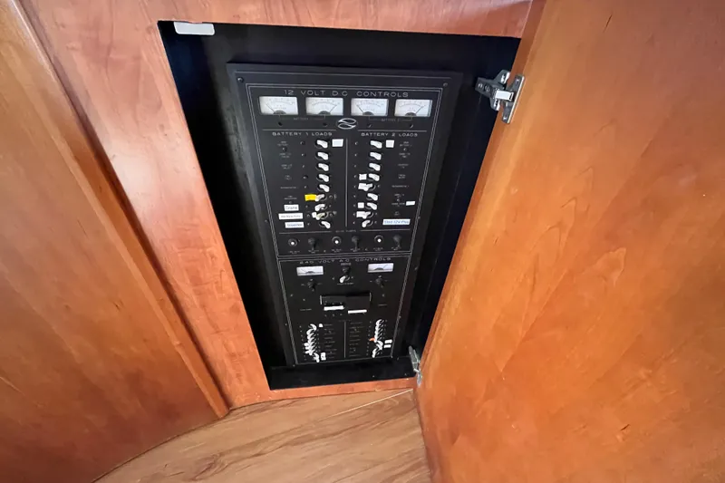 Slide: The Image of Electrical control panel inside 2001 Silverton 42C boat, featuring 12-volt DC controls. - 83