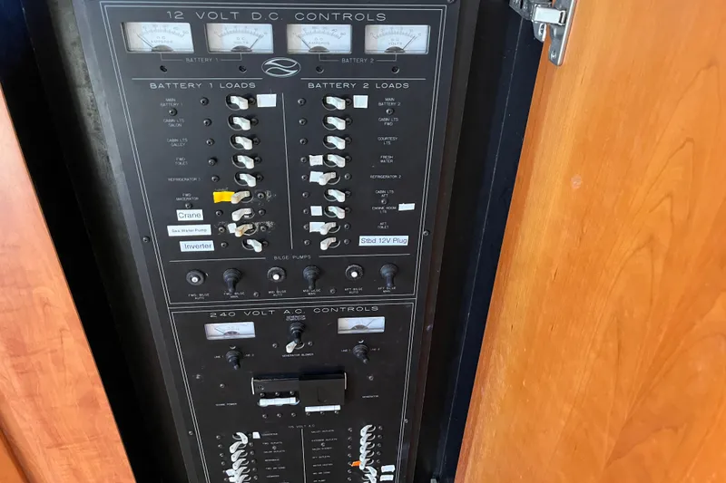 Slide: The Image of Electrical control panel on a 2001 Silverton 42C boat, featuring 12V DC and 240V AC controls. - 84