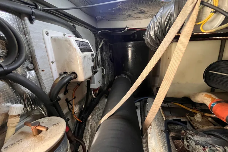 Slide: The Image of Engine room of a 2001 Silverton 42C boat, showing mechanical components and wiring. - 95