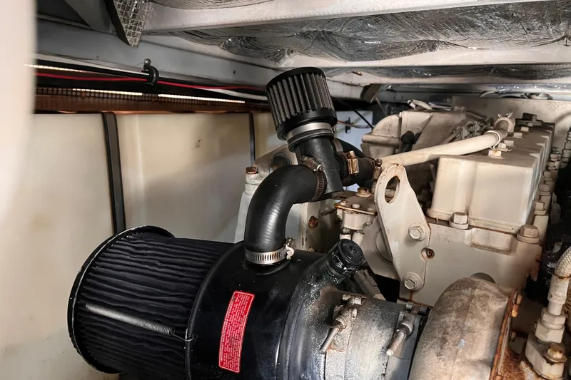 Slide: The Image of Engine compartment of a 2001 Silverton 42C boat, showcasing mechanical components and filters. - 97