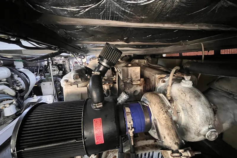 Slide: The Image of Engine compartment of a 2001 Silverton 42C boat, showcasing mechanical components. - 98