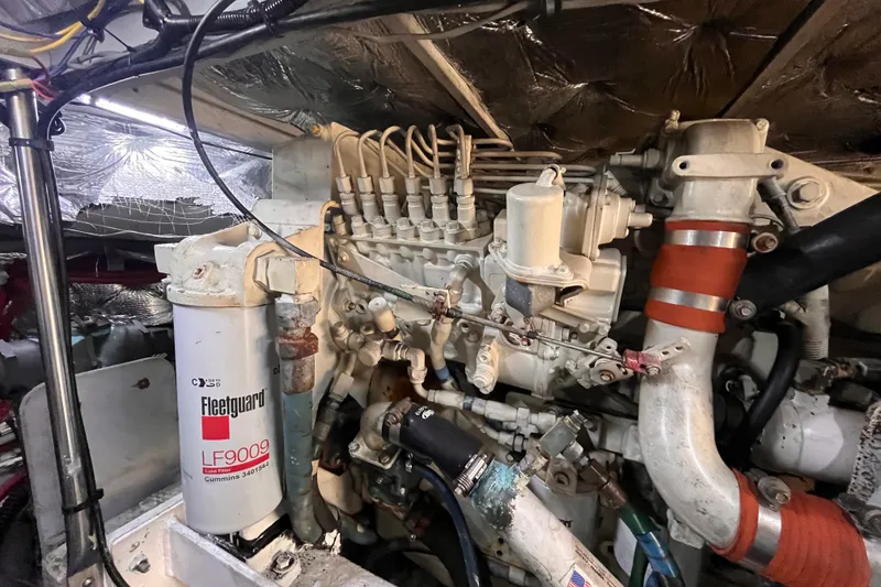Slide: The Image of Engine compartment of a 2001 Silverton 42C boat, featuring a Fleetguard LF9009 filter. - 99
