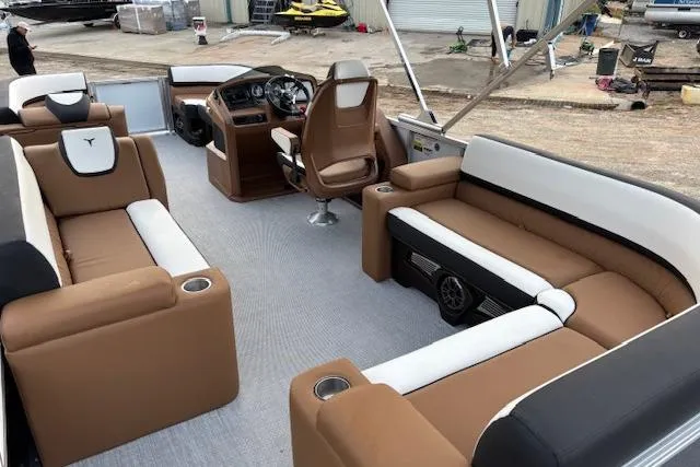 Slide: The Image of 2026 Tahoe Pontoon LTZ 2385 EL Tritoon with luxurious seating and modern helm design. - 12