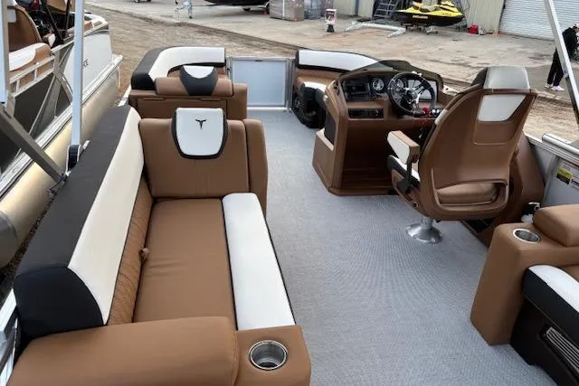 Slide: The Image of 2026 Tahoe Pontoon LTZ 2385 EL Tritoon interior with brown and white seating. - 13