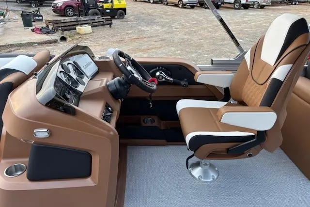 Slide: The Image of 2026 Tahoe Pontoon LTZ 2385 EL Tritoon interior with captain's chair and dashboard. - 15