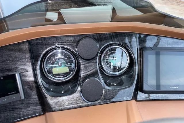 Slide: The Image of Dashboard of 2026 Tahoe Pontoon LTZ 2385 EL Tritoon with gauges and Garmin display. - 18