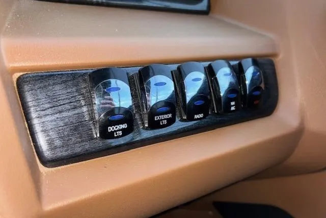 Slide: The Image of Control panel of 2026 Tahoe Pontoon LTZ 2385 EL Tritoon with labeled switches. - 24