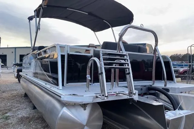 Slide: The Image of 2026 Tahoe Pontoon LTZ 2385 EL Tritoon with canopy, docked outdoors. - 6