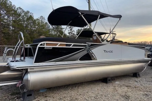 Slide: The Image of 2026 Tahoe Pontoon LTZ 2385 EL Tritoon with canopy, parked on gravel. - 7