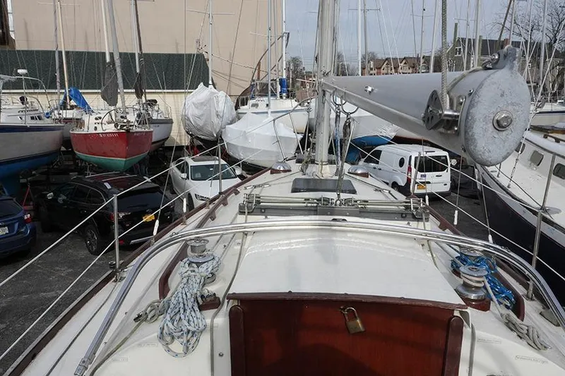 Slide: The Image of 1978 Bristol 29.9 sailboat in a crowded marina with other boats and vehicles. - 14