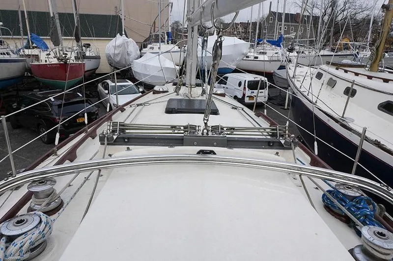 Slide: The Image of 1978 Bristol 29.9 sailboat deck view in a marina with surrounding boats. - 15