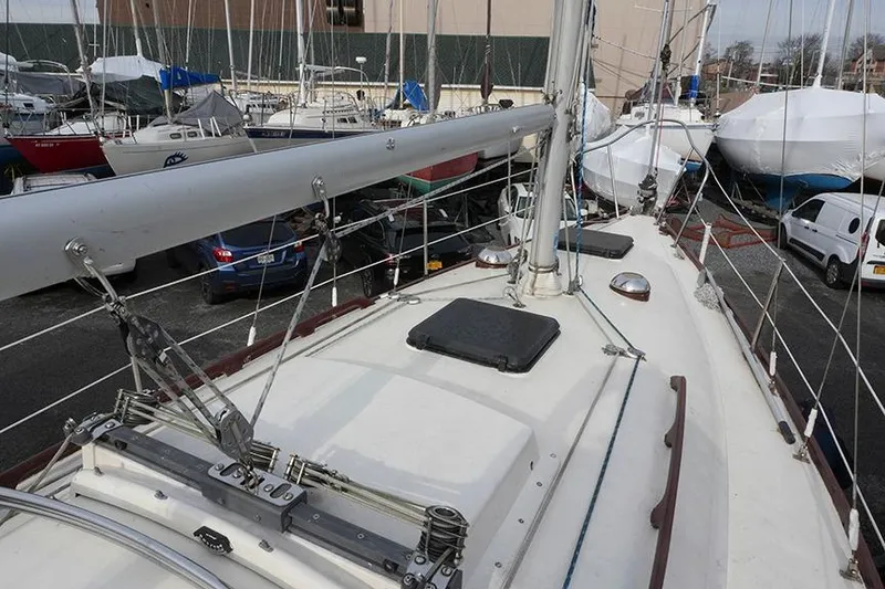 Slide: The Image of 1978 Bristol 29.9 sailboat deck view in a marina with other boats. - 18