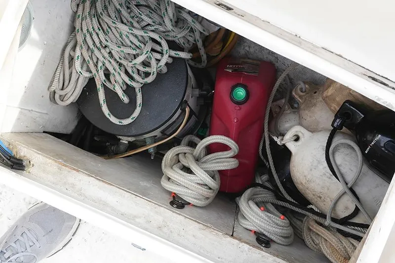 Slide: The Image of Storage compartment of a 1978 Bristol 29.9 sailboat with ropes and equipment. - 28