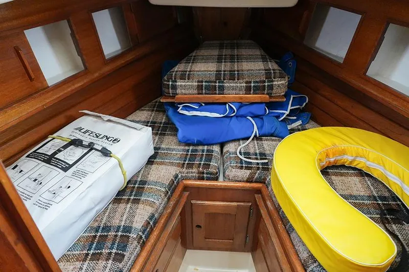 Slide: The Image of Interior of 1978 Bristol 29.9 sailboat with plaid cushions and safety equipment. - 39