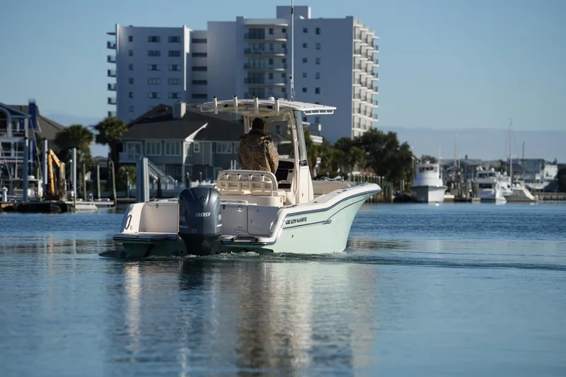Slide: The Image of 2018 Grady-White Fisherman 236 boat cruising near waterfront buildings. - 20