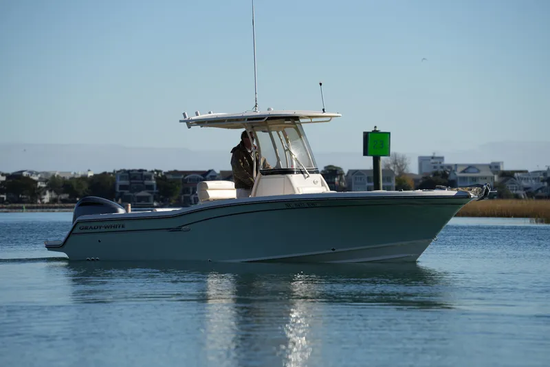 Slide: The Image of 2018 Grady-White Fisherman 236 boat on calm water near shoreline. - 3