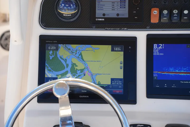 Slide: The Image of 2018 Grady-White Fisherman 236 dashboard with Garmin navigation and fishfinder displays. - 33