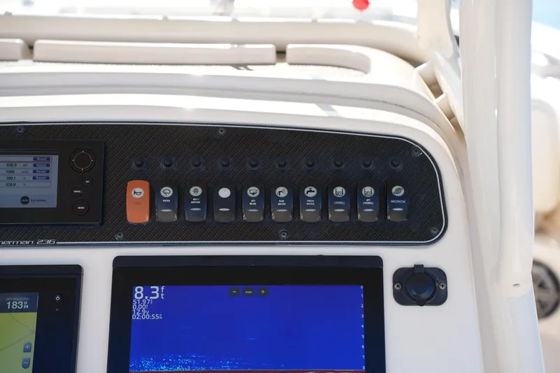 Slide: The Image of Control panel of 2018 Grady-White Fisherman 236 boat with switches and display screens. - 35